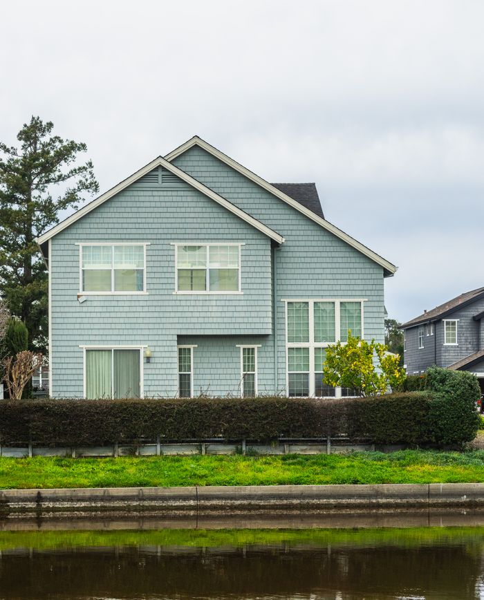 A contemporary detached house in a suburban neighborhood with a scenic canal front.